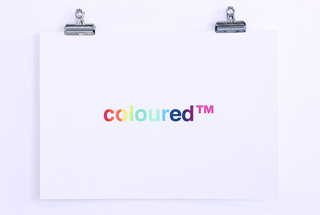 Serigraph that has the words colouredtm printed in rainbow colours across the text.